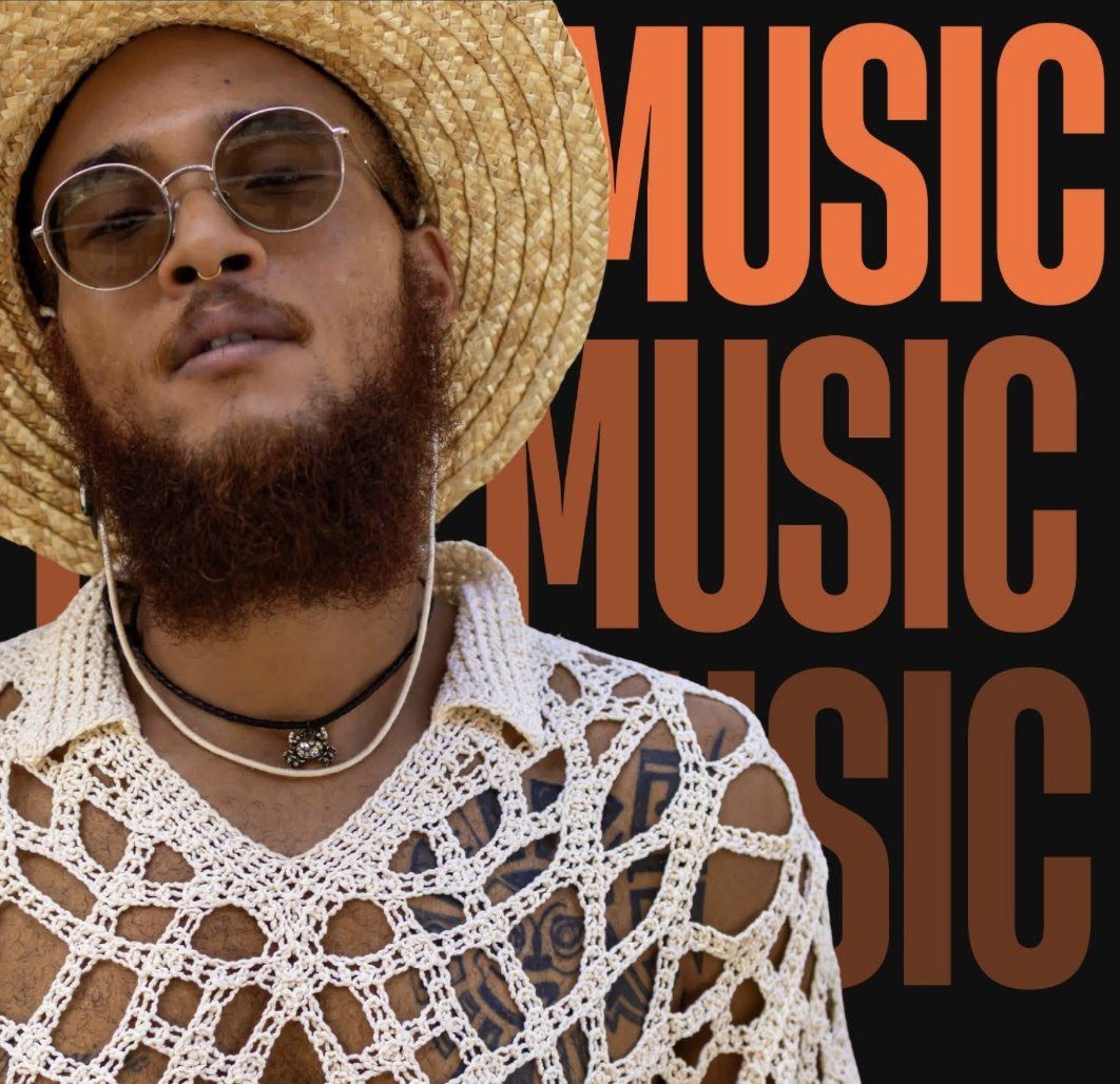 Isaiah Da Artist in a straw hat, round sunglasses and a crochet top, in front of orange lettering that reads Music.